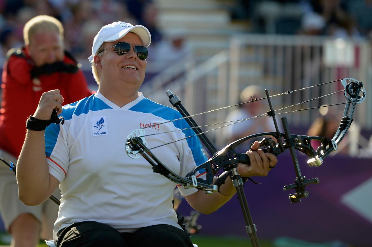 Finnish male archer celebrates after winning Paralympic gold