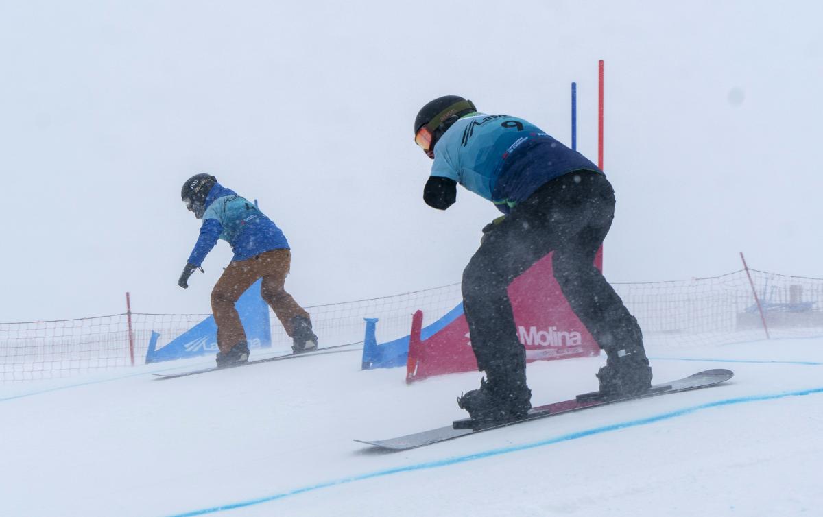 Two Para snowboarders competing side by side