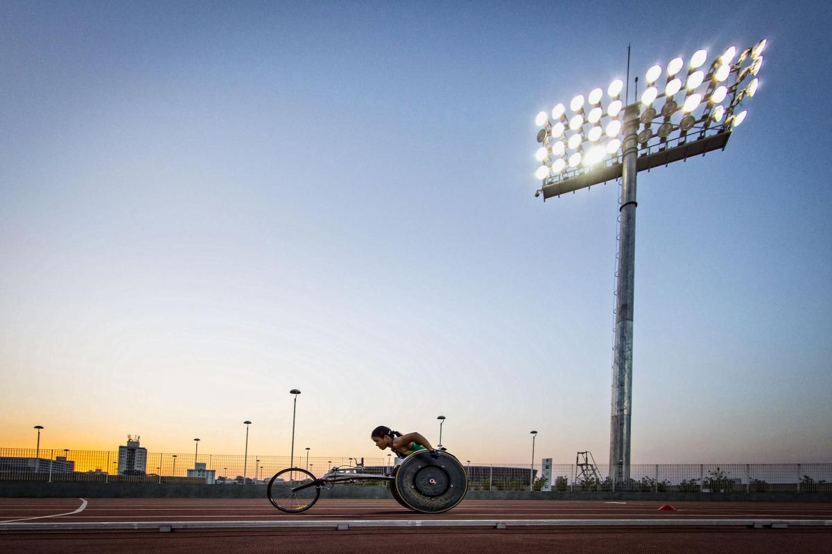 A female wheelchair racer on an athletics track