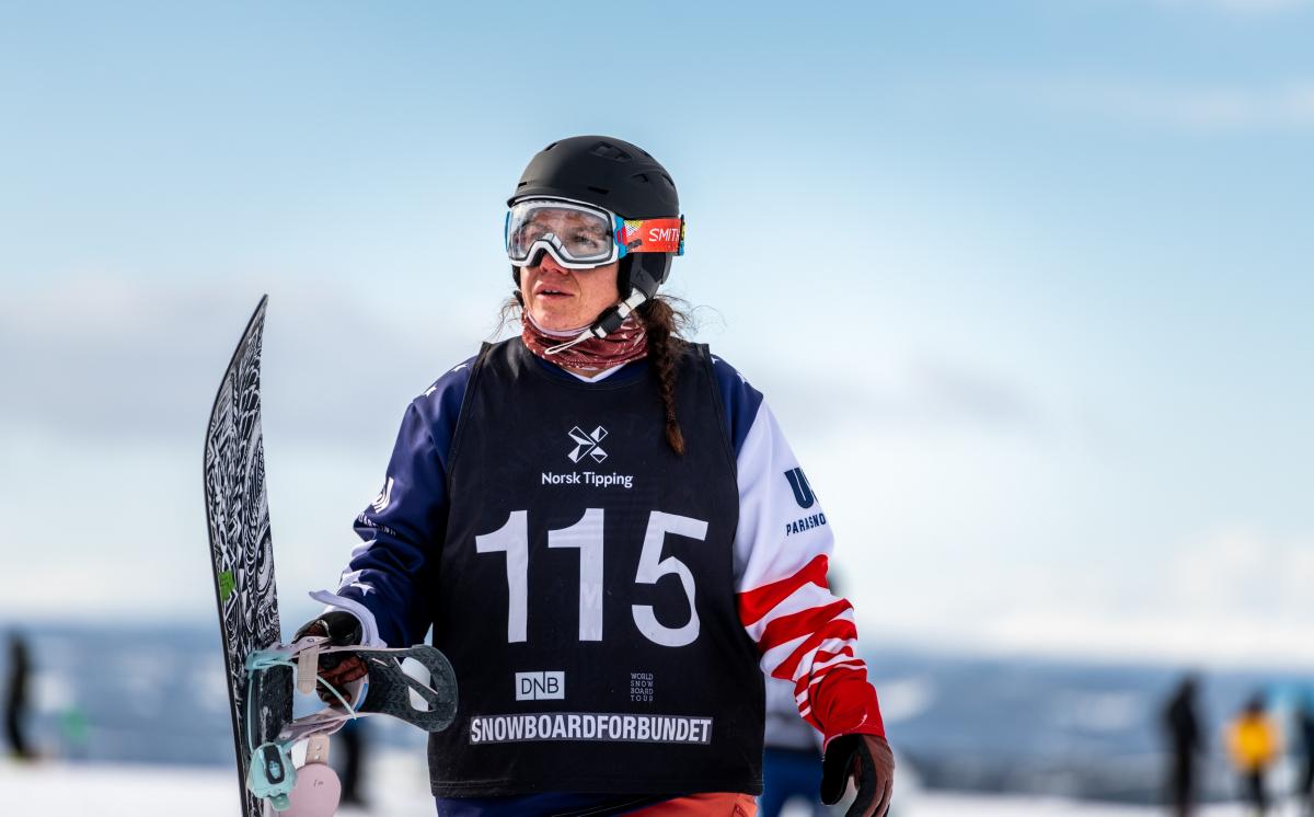 A woman holding her snowboard