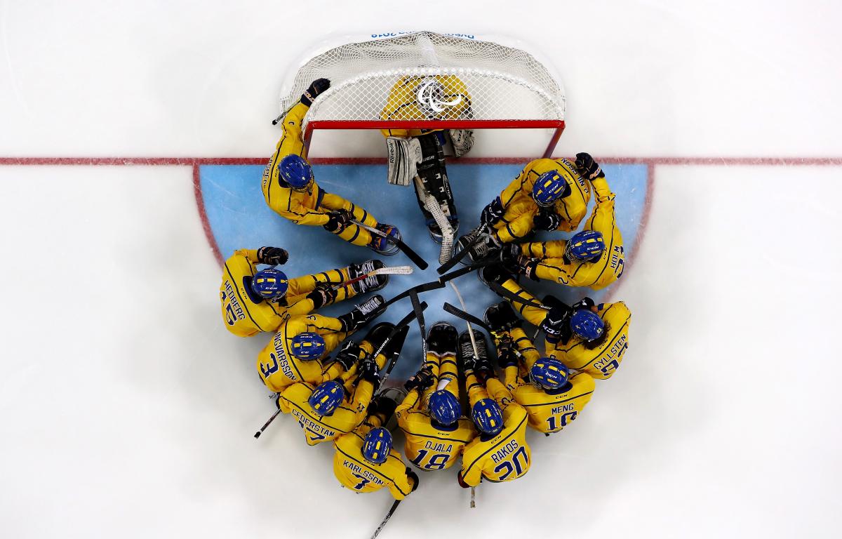 A Para ice hockey team on the ice seen from above