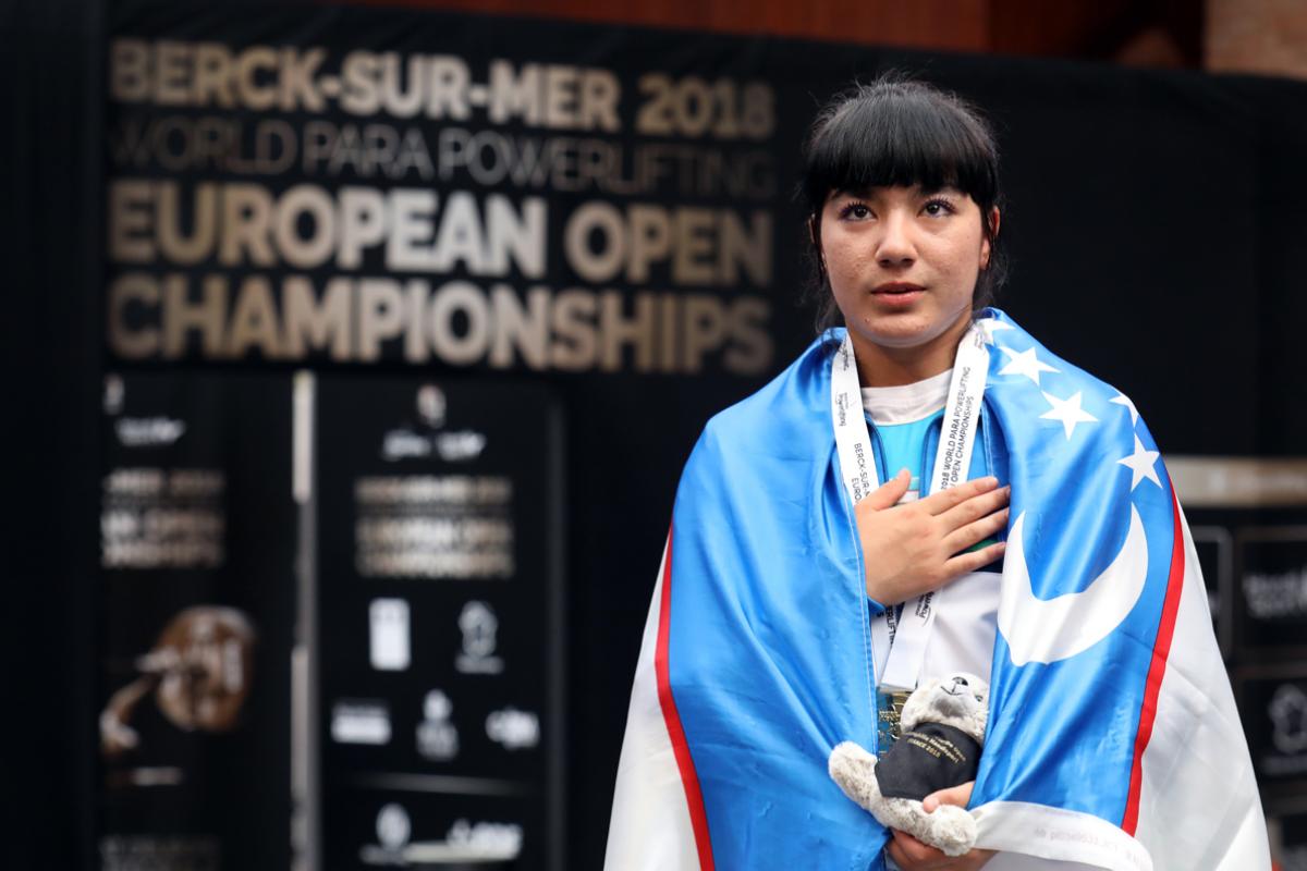 Shakhzoda Mamadalieva touching her chest with her right hand 