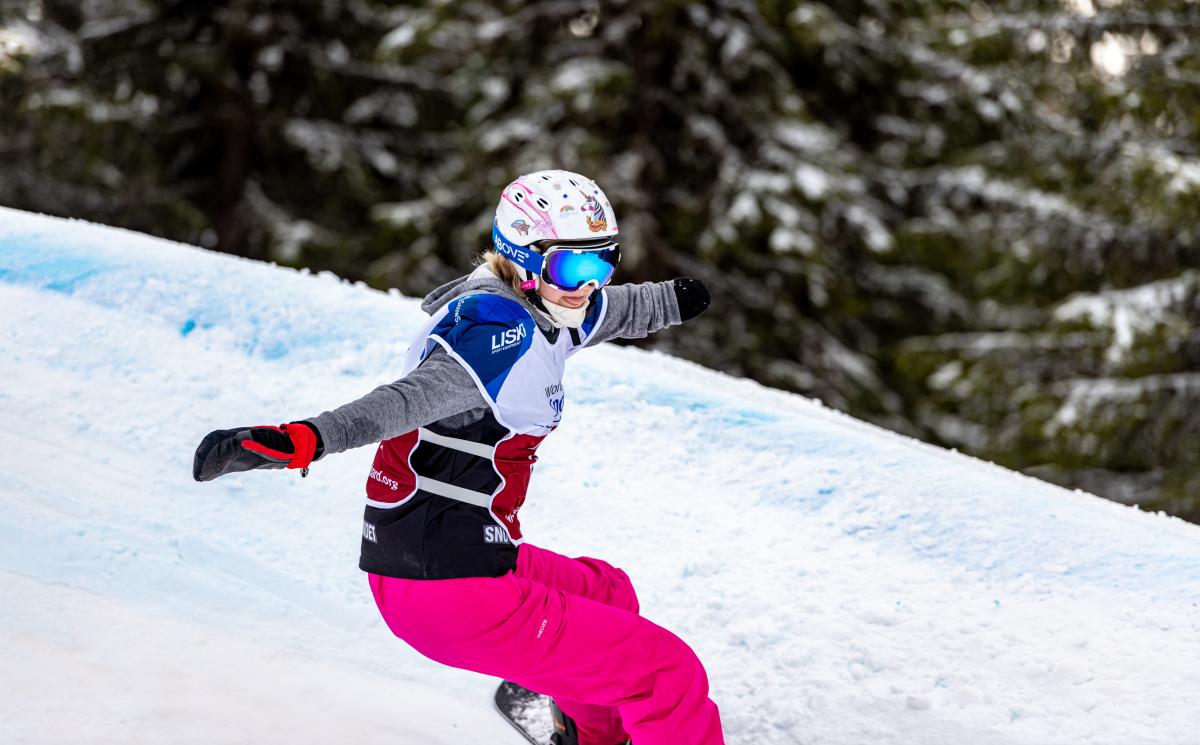 A female Para snowboarder competing 