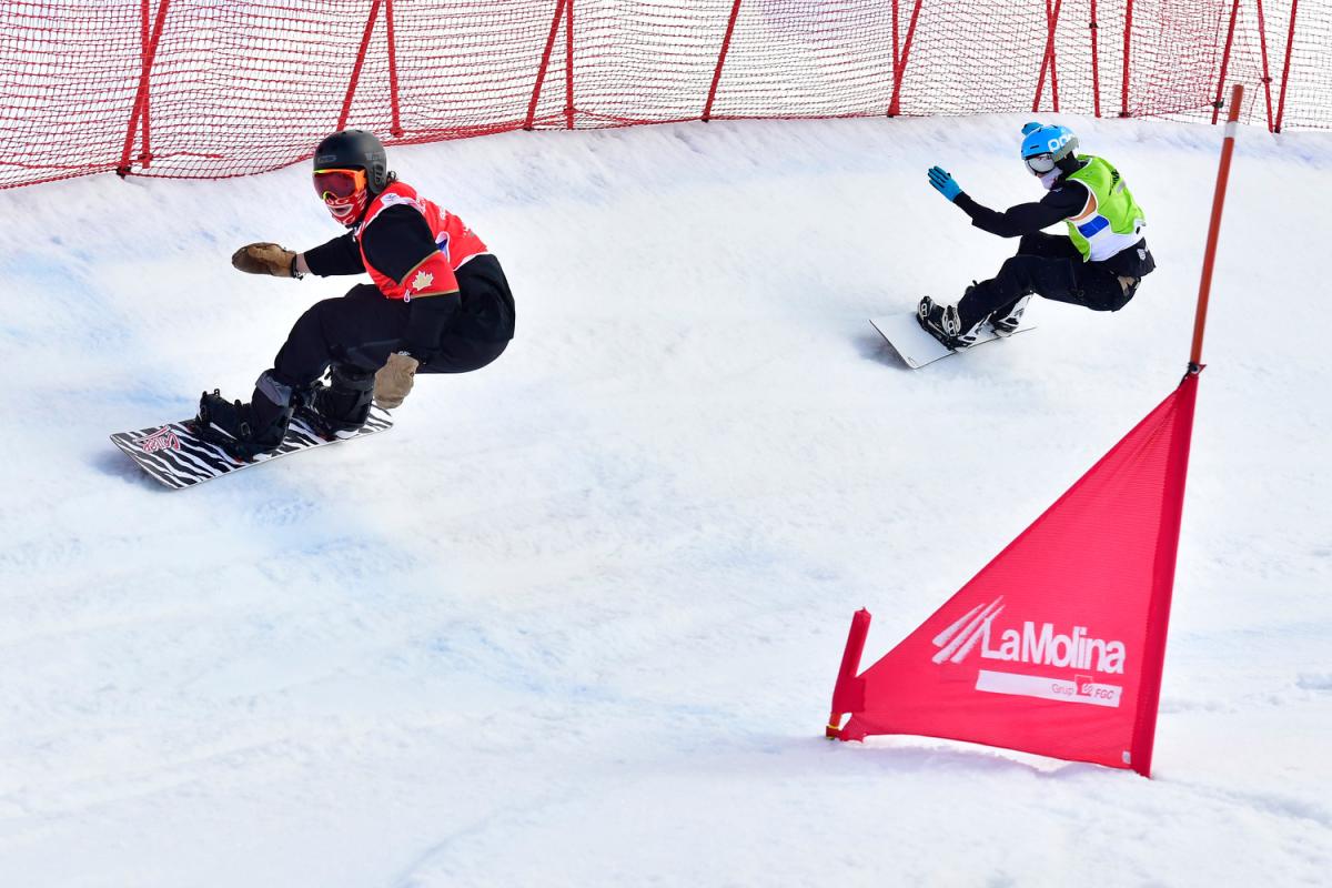 Two male Para snowboarders competing