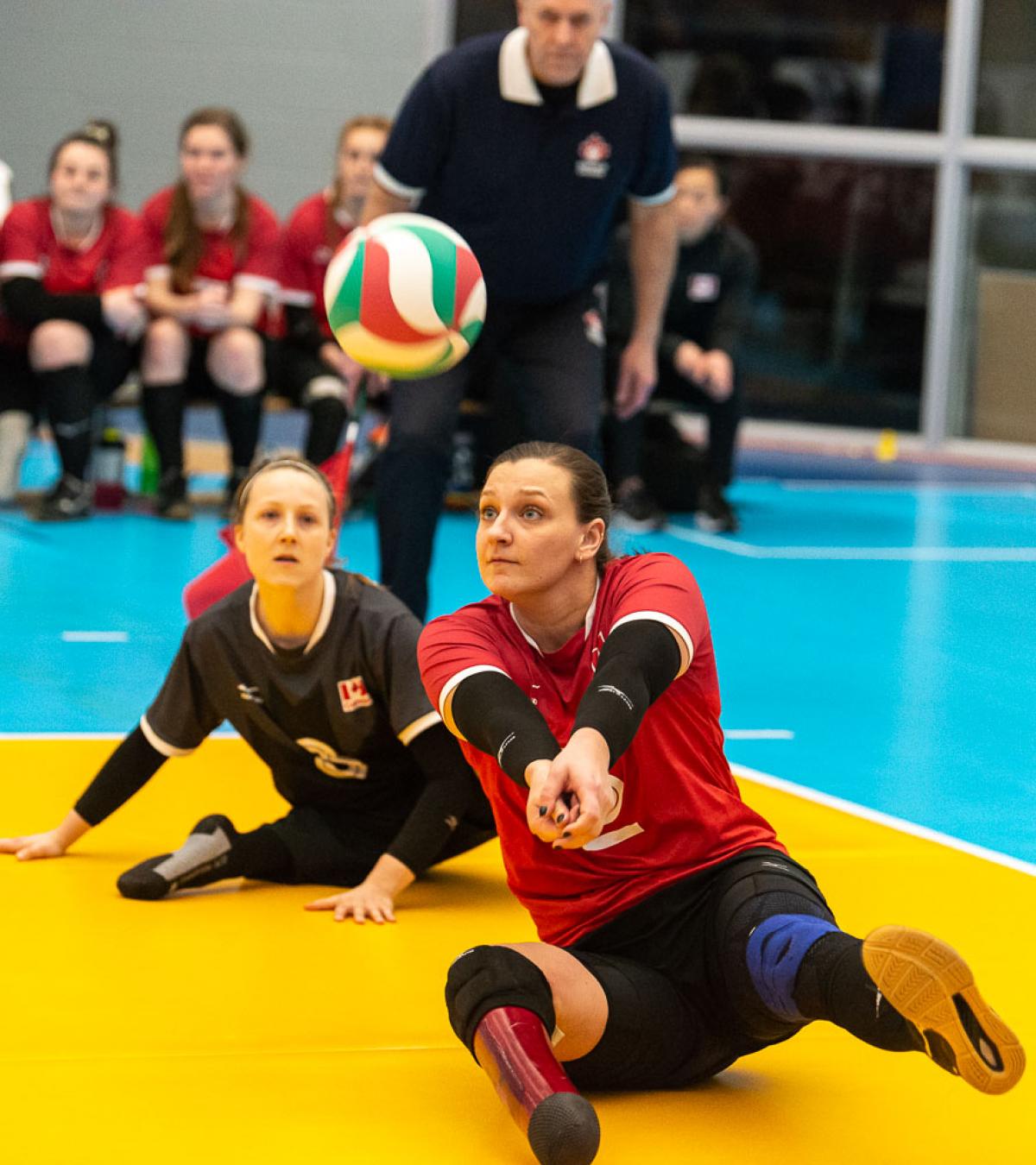 Female sitting volleyball player hits a bump
