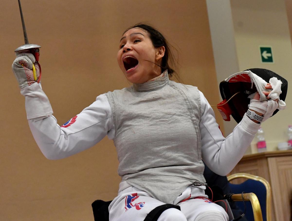 Female wheelchair fencer celebrates