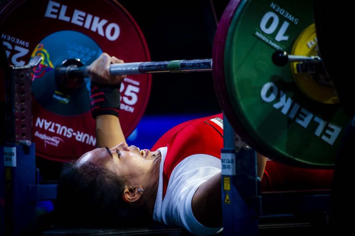 A woman preparing to lift a bar