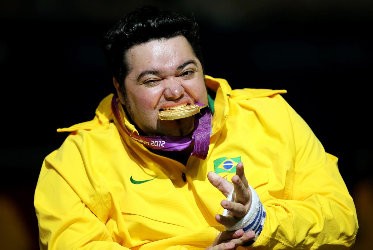 Male boccia player bites his Paralympic gold medal