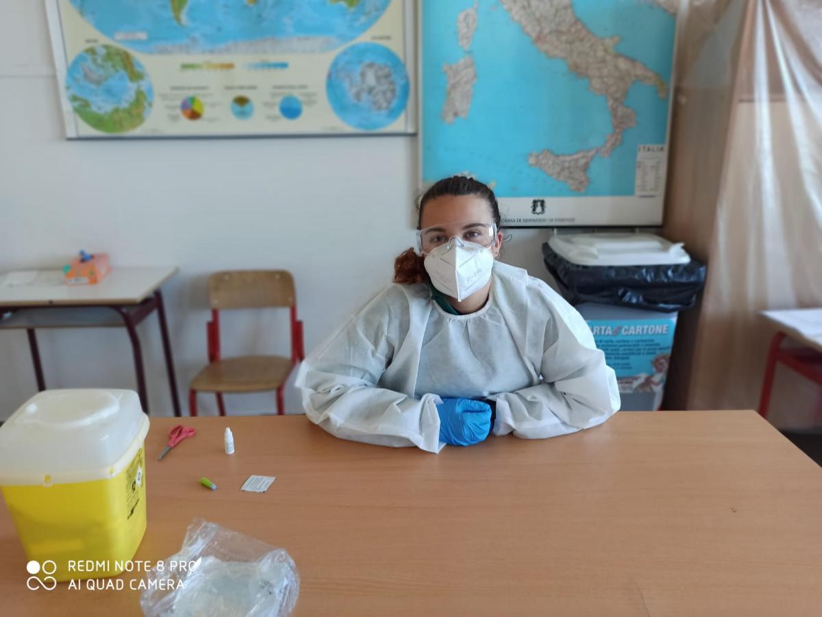 Italian female dressed in protective equipment with face mask, goggles and gloves