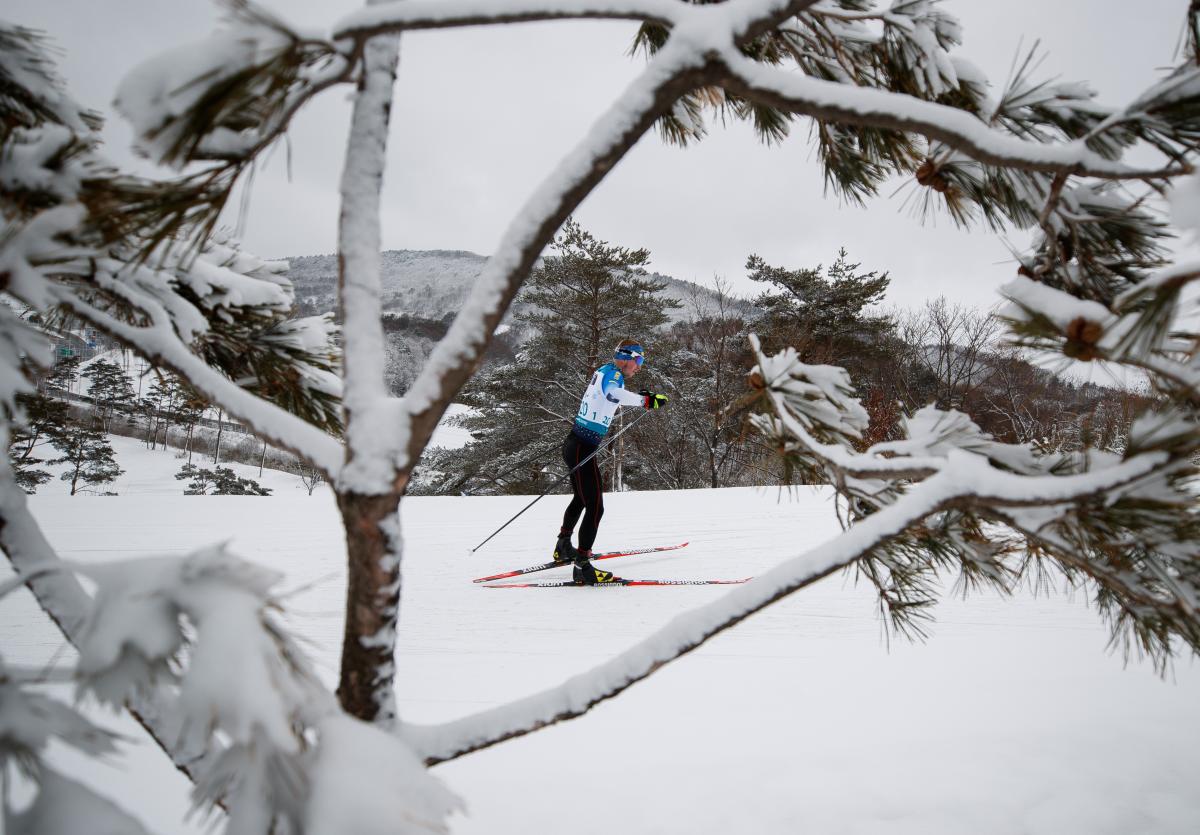 A man competing in cross-country in the snow