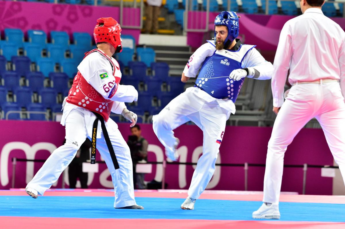 Two male taekwondo fighters sparring