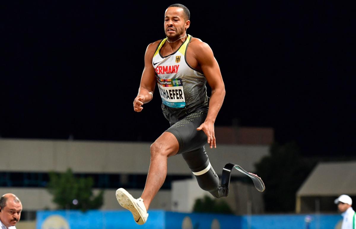 A man with a prosthetic leg jumping 