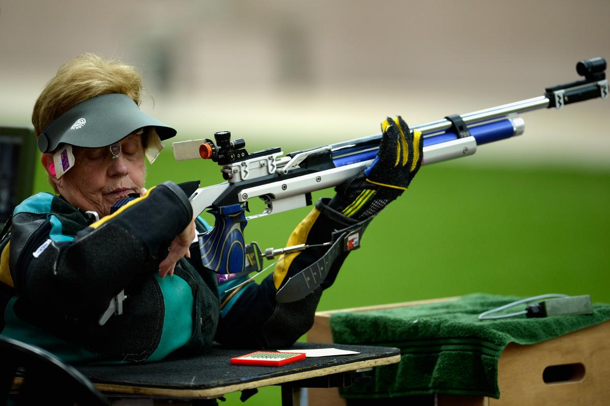 A woman competing with a rifle in a shooting range
