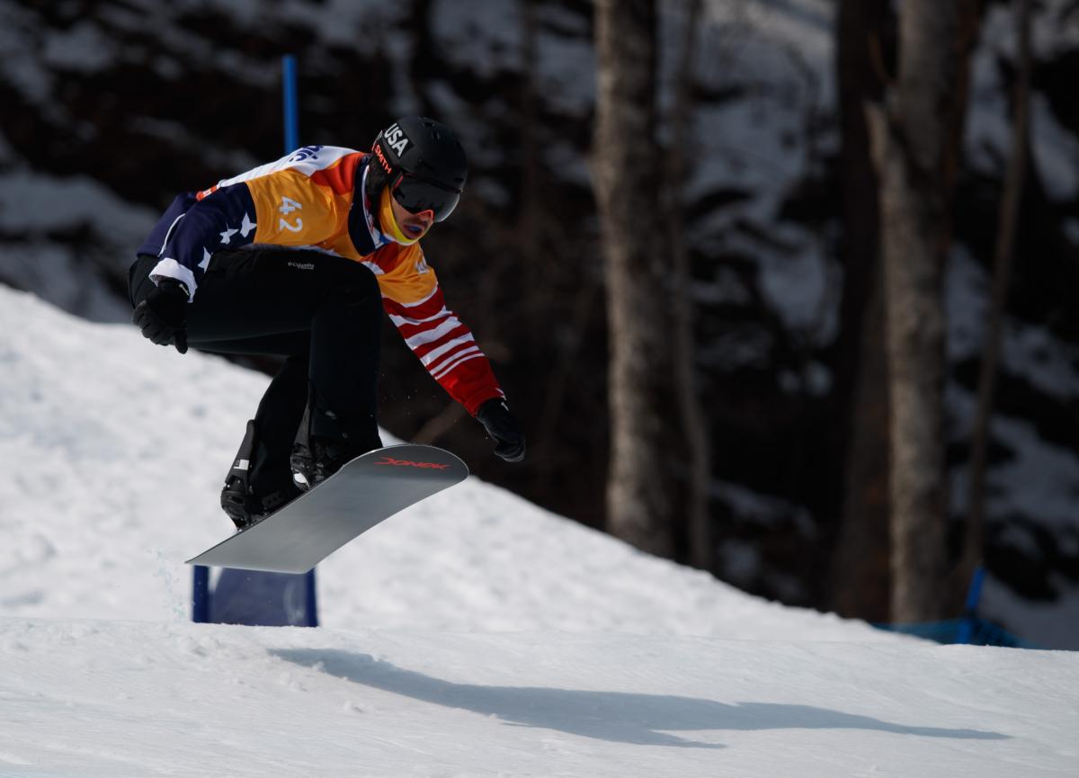 A male Para snowboarder competing 