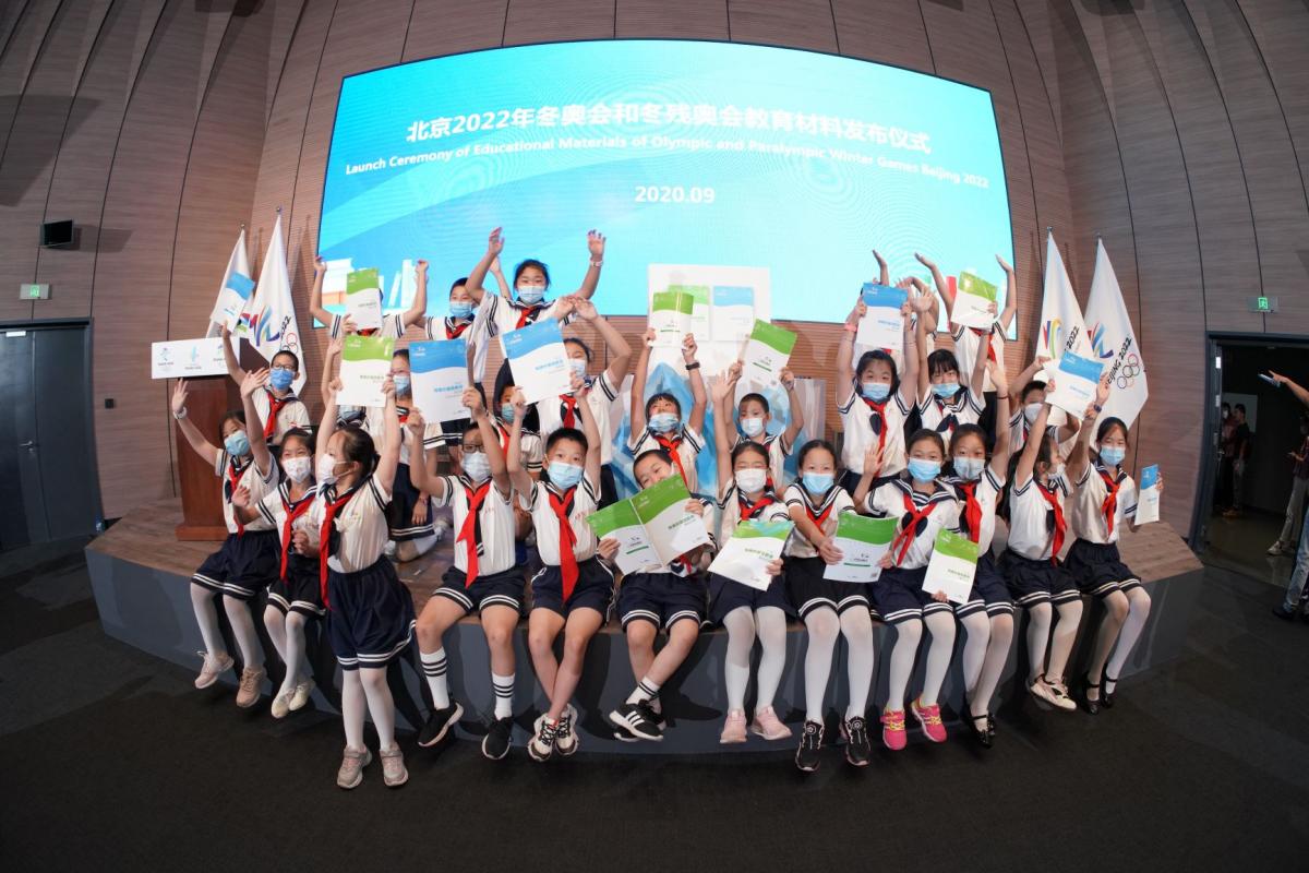 Chinese school kids with hands in the air