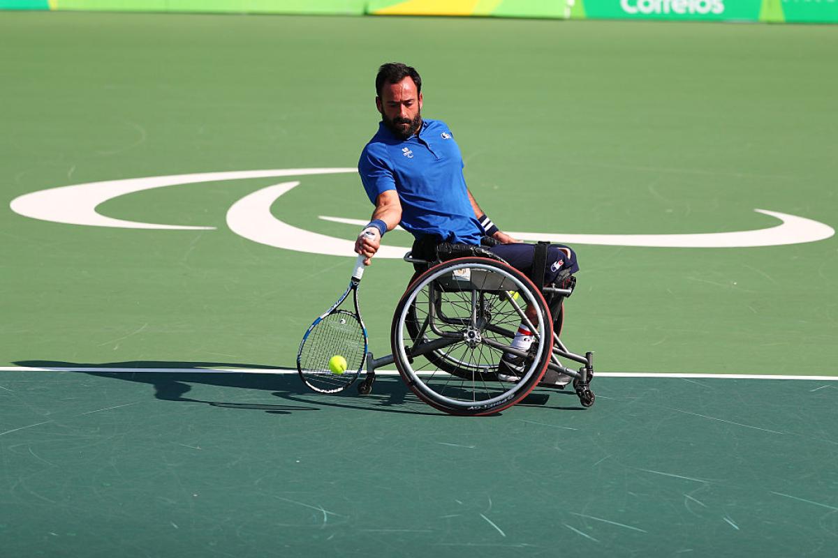 French man in wheelchair returns tennis shot