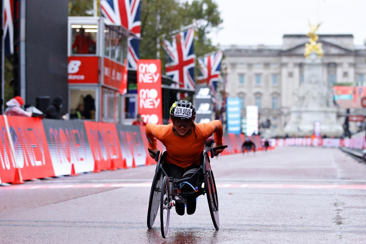 A female wheelchair racer crossing the line in the streets of London