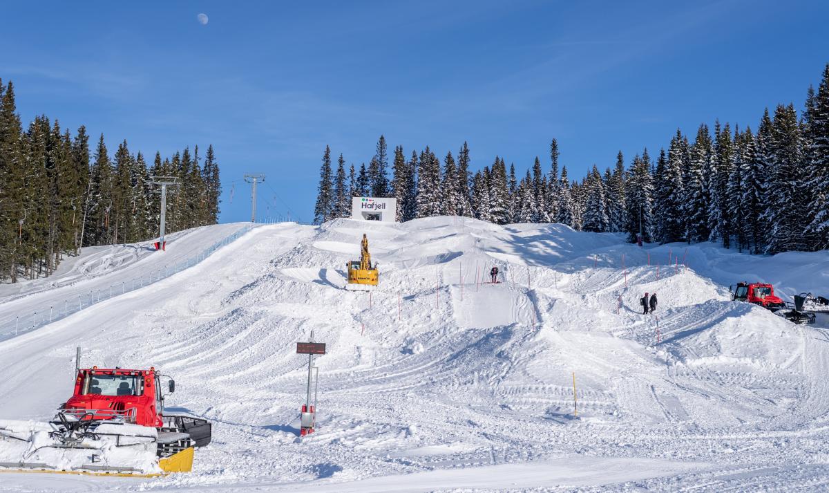 Three snowcats moving the snow to build a Para snowboard course