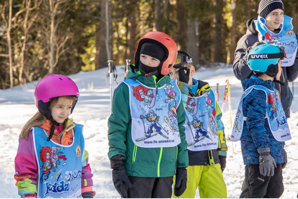 Four children and a man on the snow