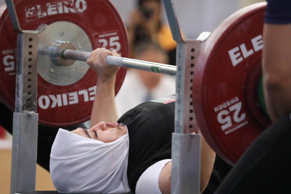 Female UAE powerlifter about to push the bar