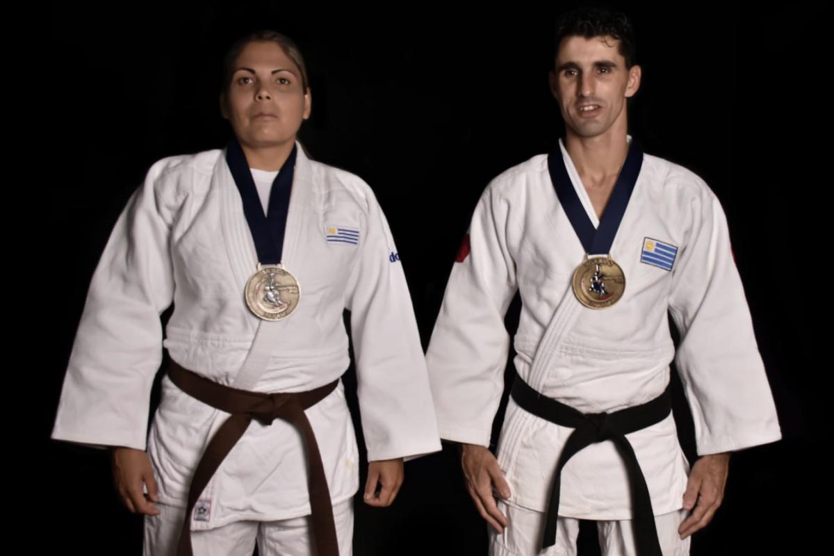 Henry Borges and Mariana Mederos standing with the Lima 2019 medals hanging on their necks
