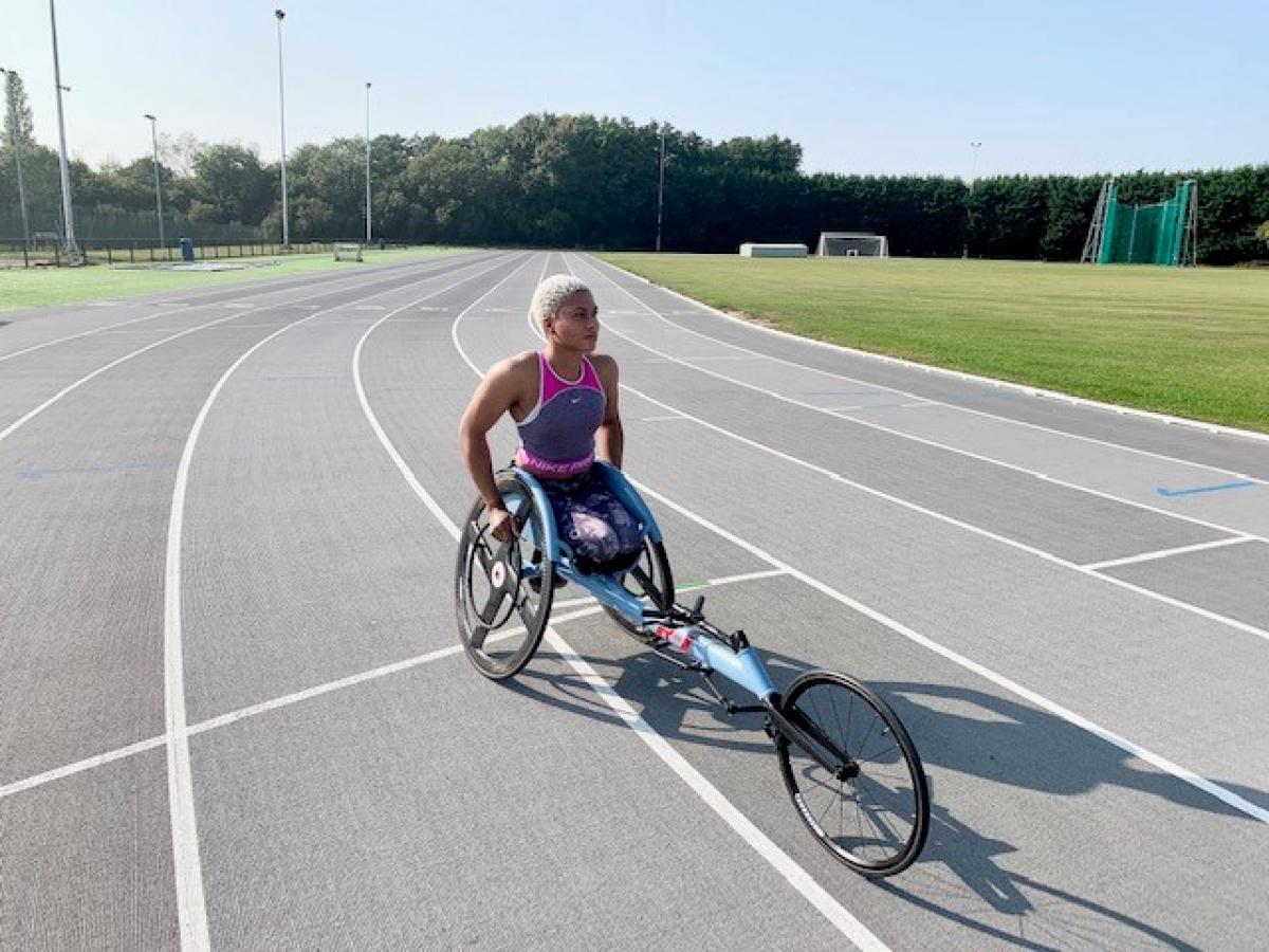 Black female wheelchair racer in her racing chair on the track