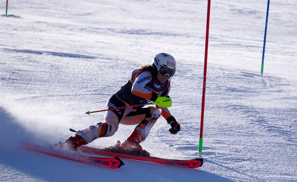 A woman competing in an alpine skiing slalom competition 