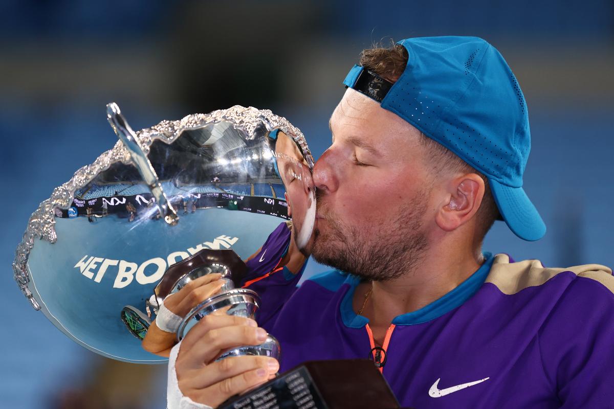 Dylan Alcott kisses Australian Open trophy