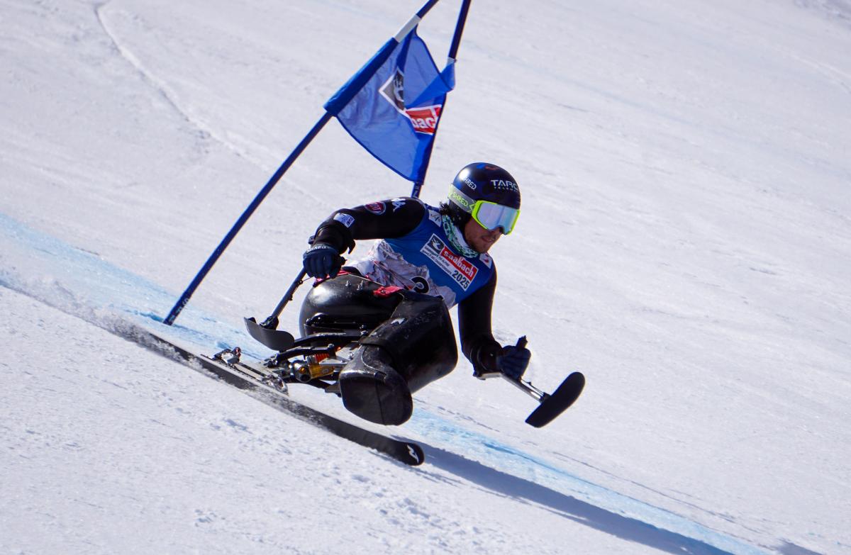 Male sit-skier makes a turn
