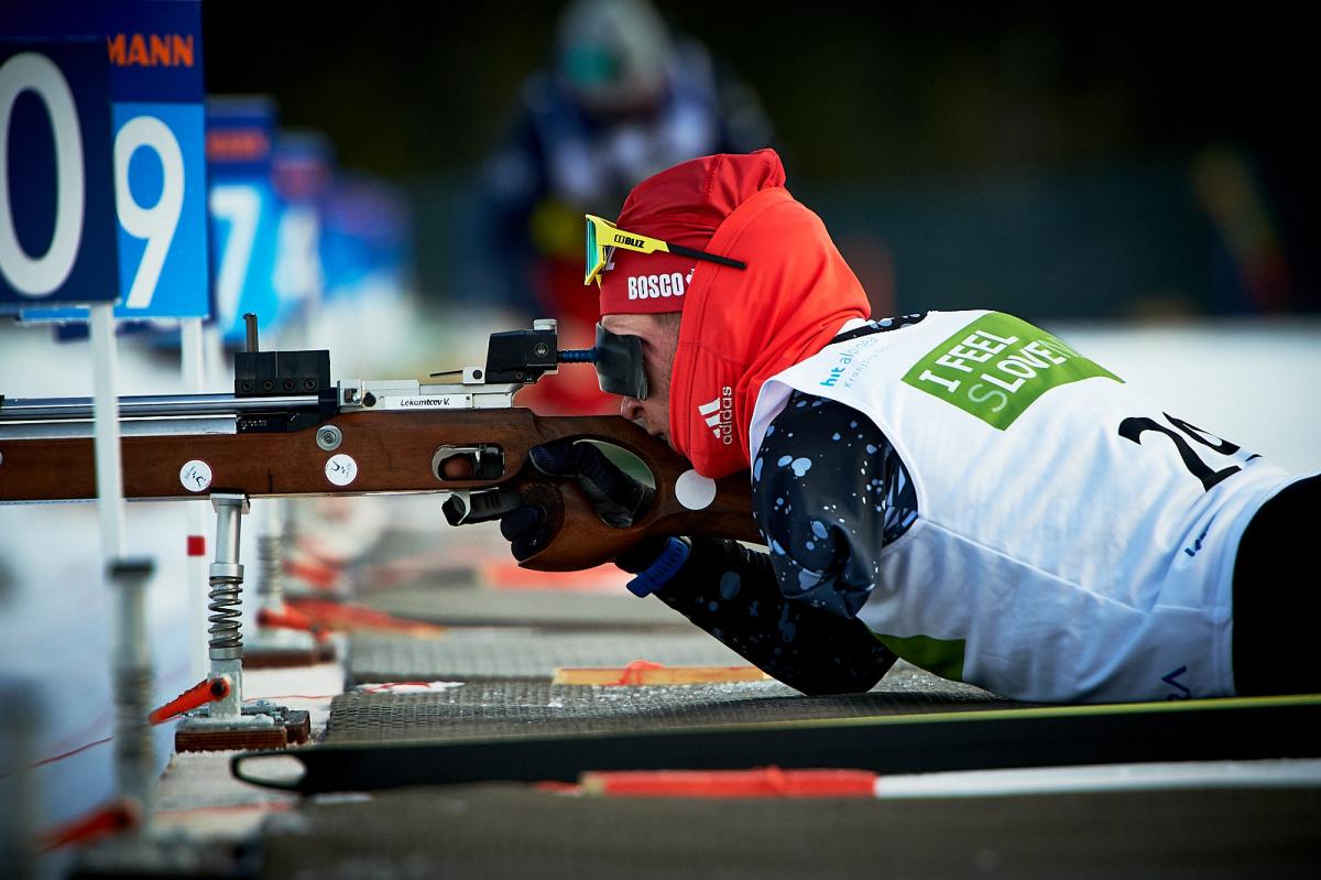 A men without the left arm shooting with a rifle during a Para biathlon competition