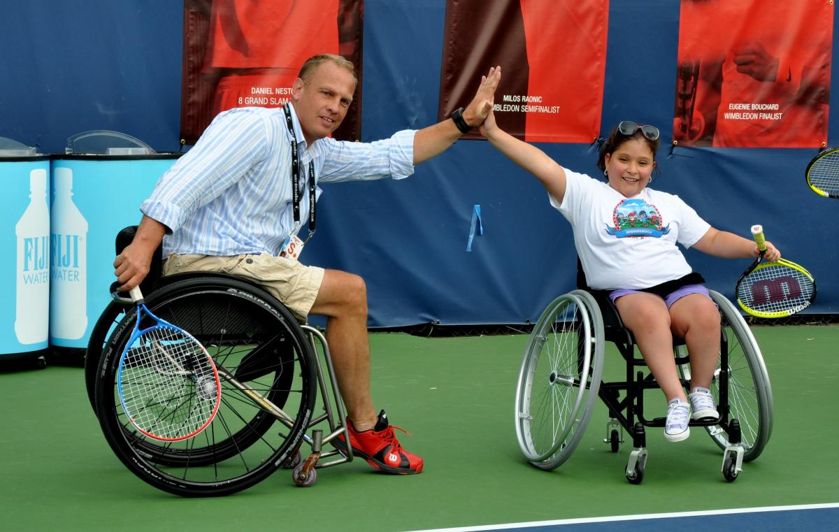 Kai Schrameyer high-fives a kid