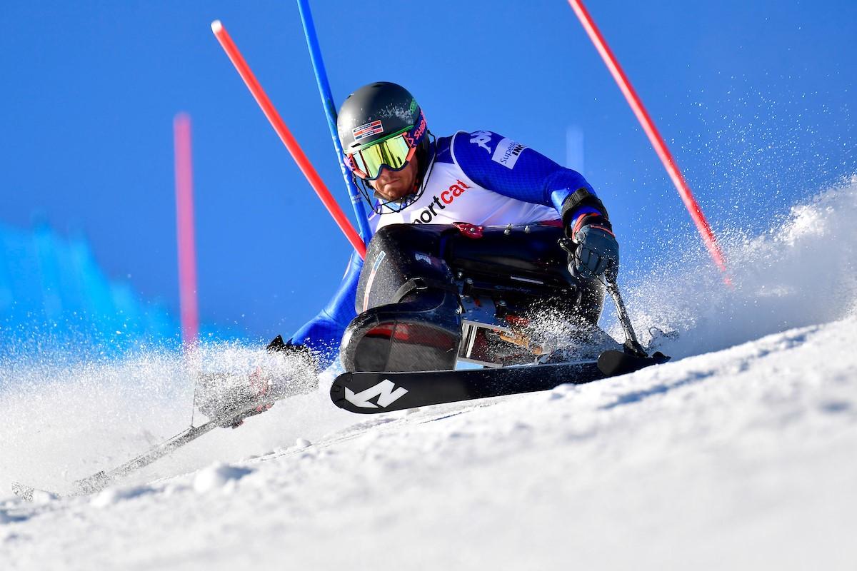 A male sit-skier in a slalom competition