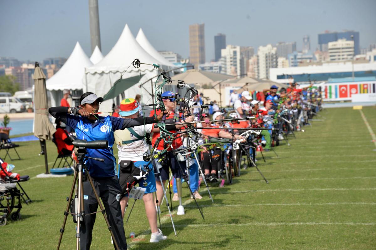 Female Para archers lined up preparing to shoot