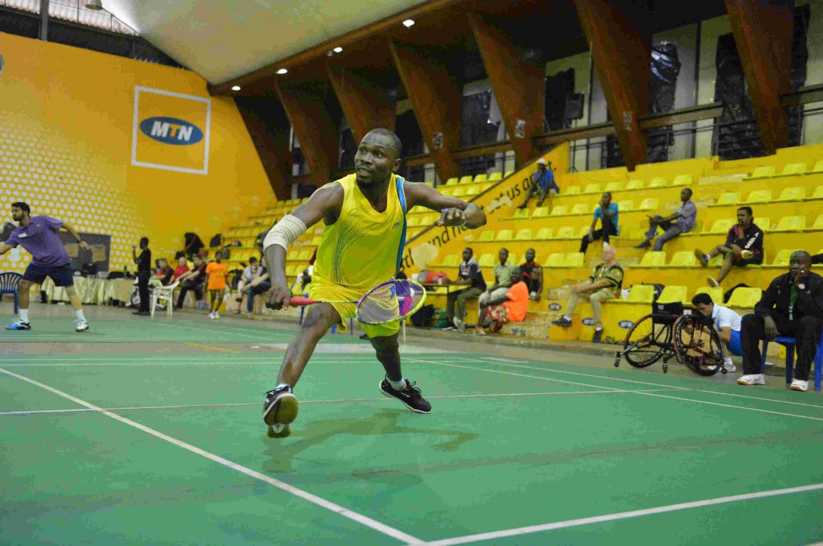 Nigerian man reaches to return the shuttle in badminton