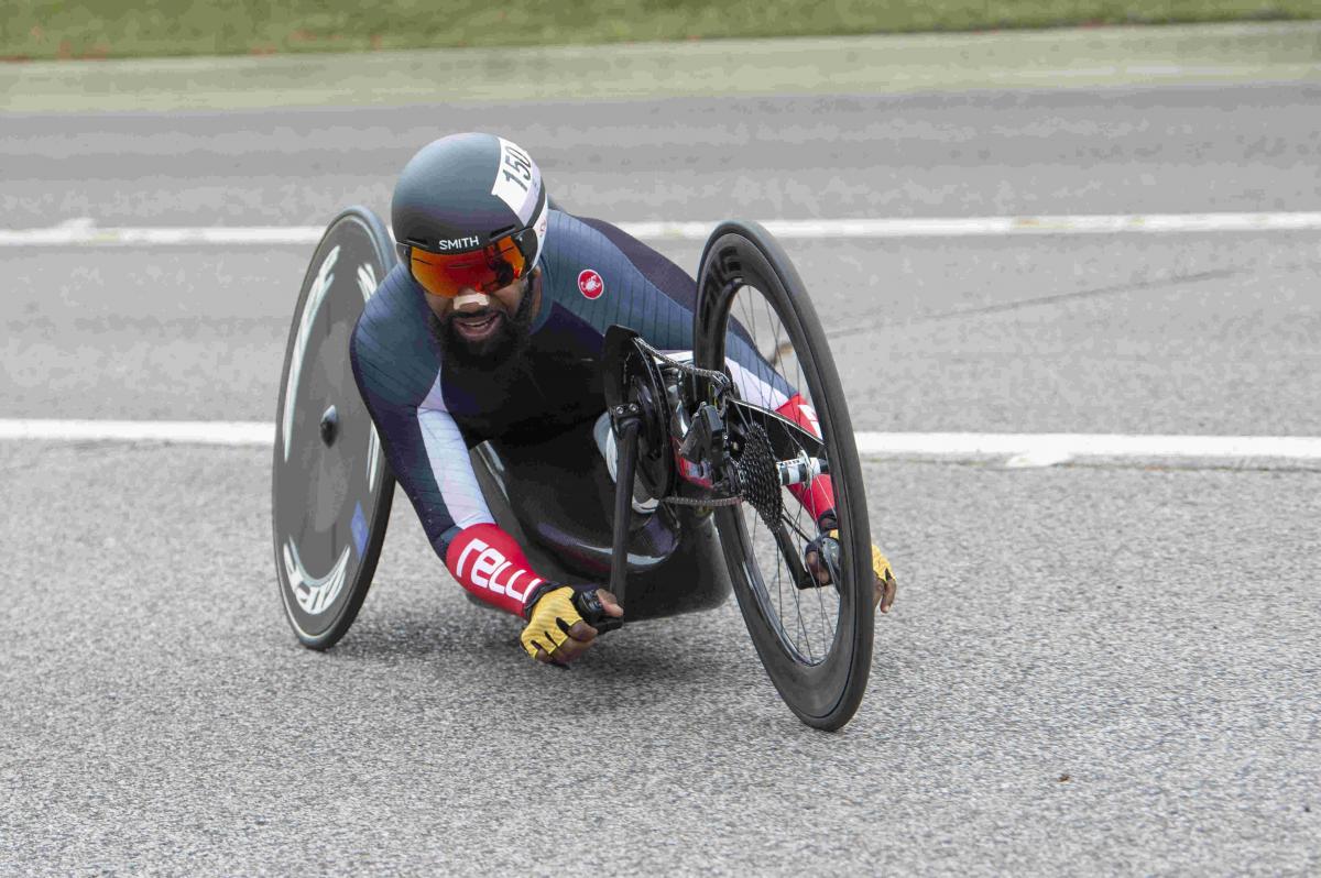 Male handcyclist rounds a corner