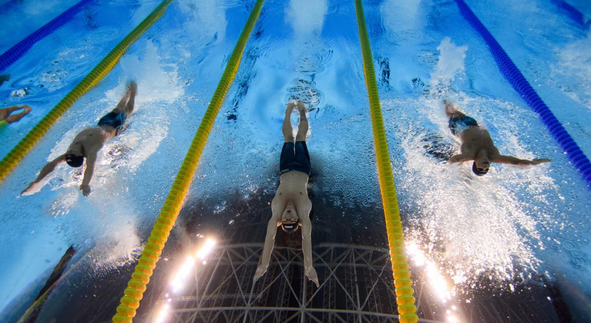 An underwater image of three male Para swimmers