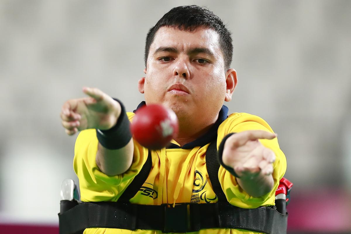Colombia male boccia player throws the ball