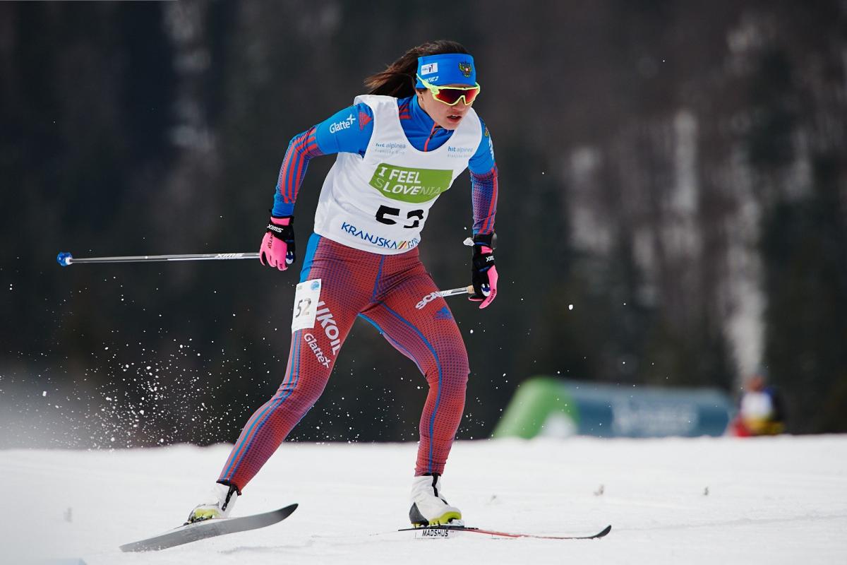 A female cross-country skier in competition