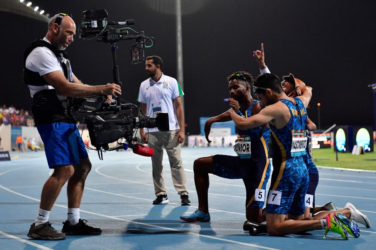 Brazilian track team on the track posing for the camera