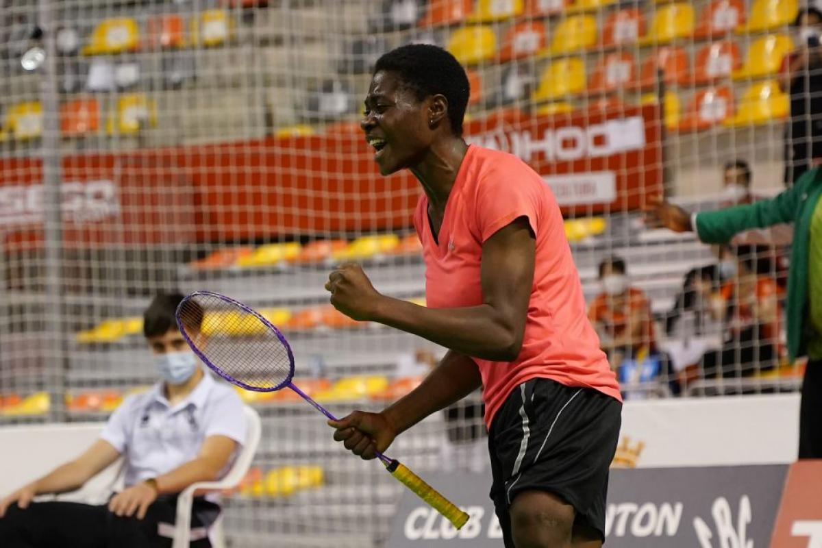 Nigerian Para badminton player Mariam Eniolo Bolaji celebrates with a clinched fist and a scream while holding her racket