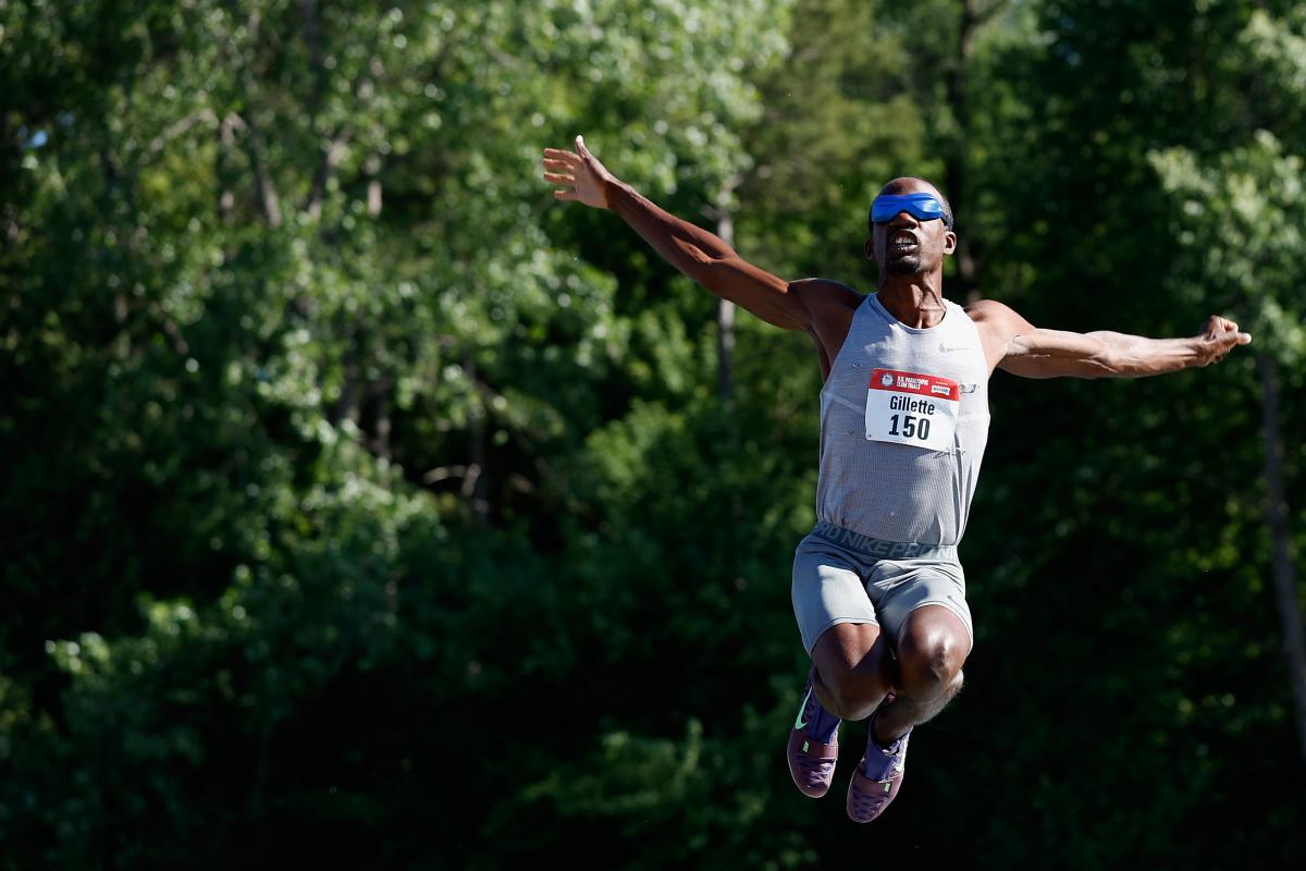 A man blindfolded jumping