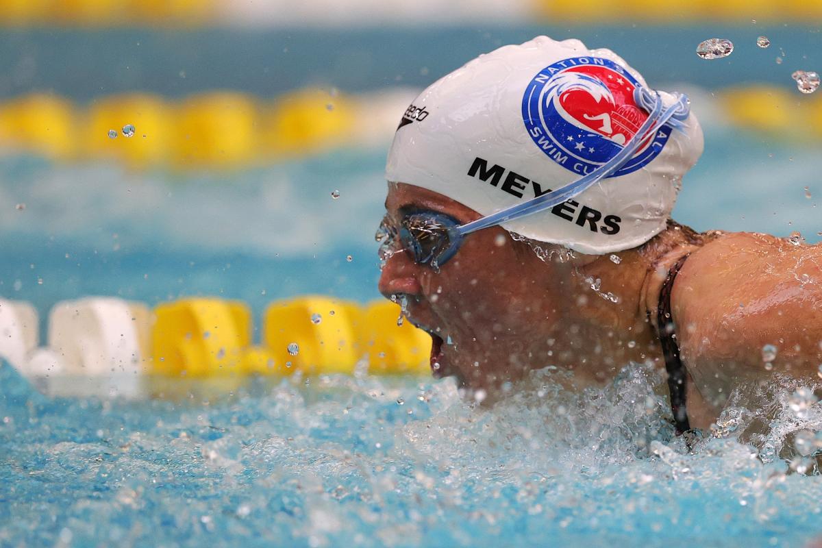 A woman putting her head out of the water during a swimming competition