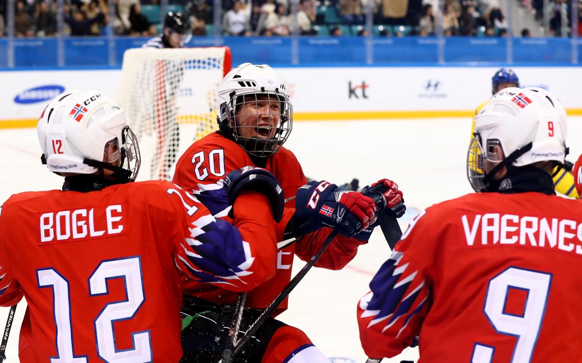 Three Norwegian Para ice hockey players celebrating on ice