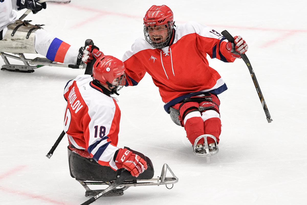 Two Para ice hockey players celebrating on ice