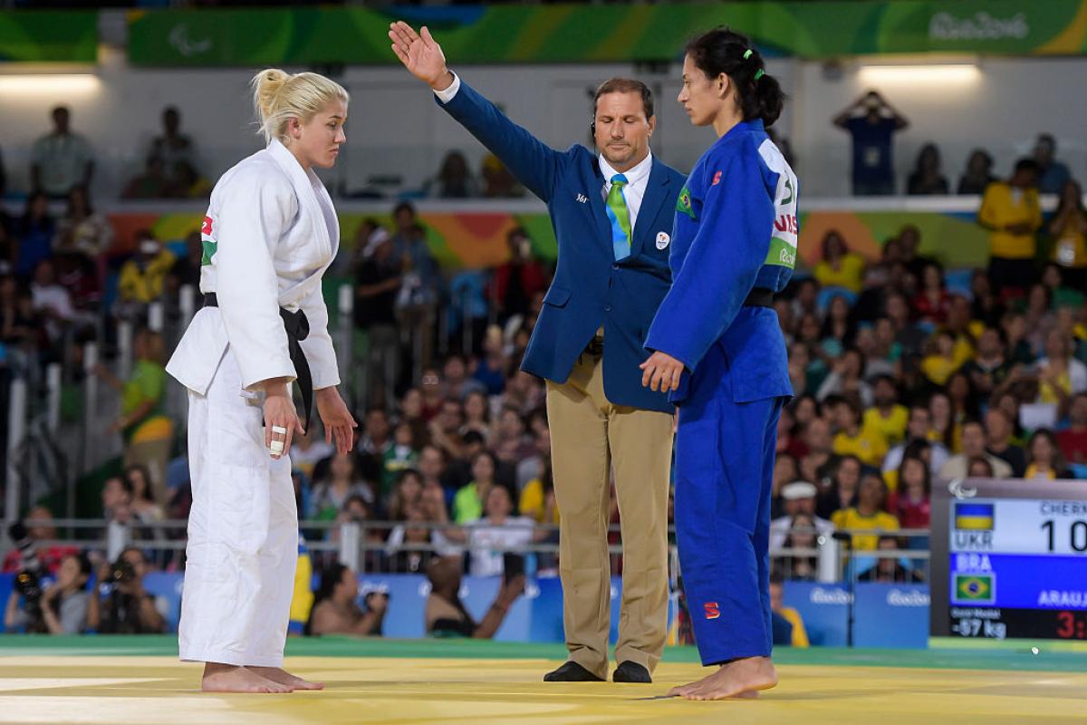 Two female judoka face each other before competing
