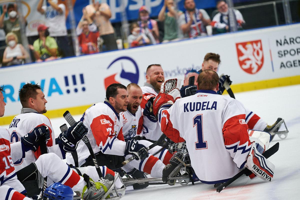 A group of Para ice hockey players celebrating on ice