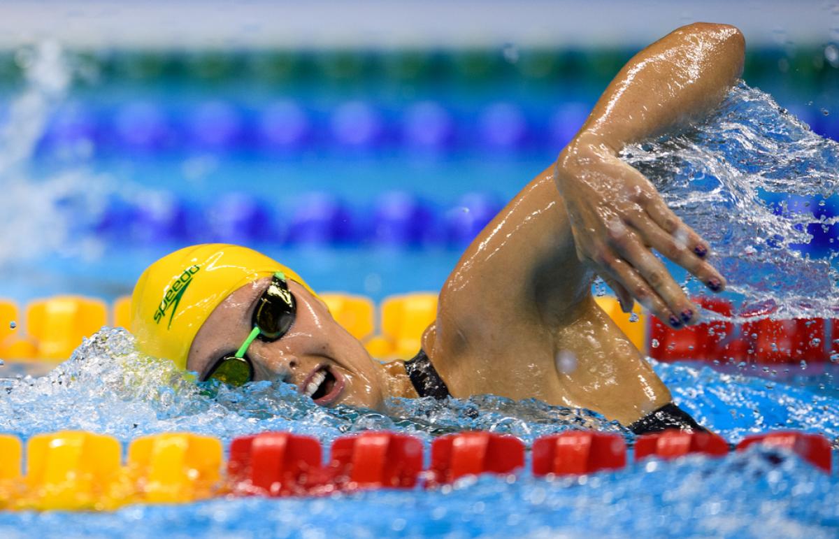 A woman swimming in a pool during a competition