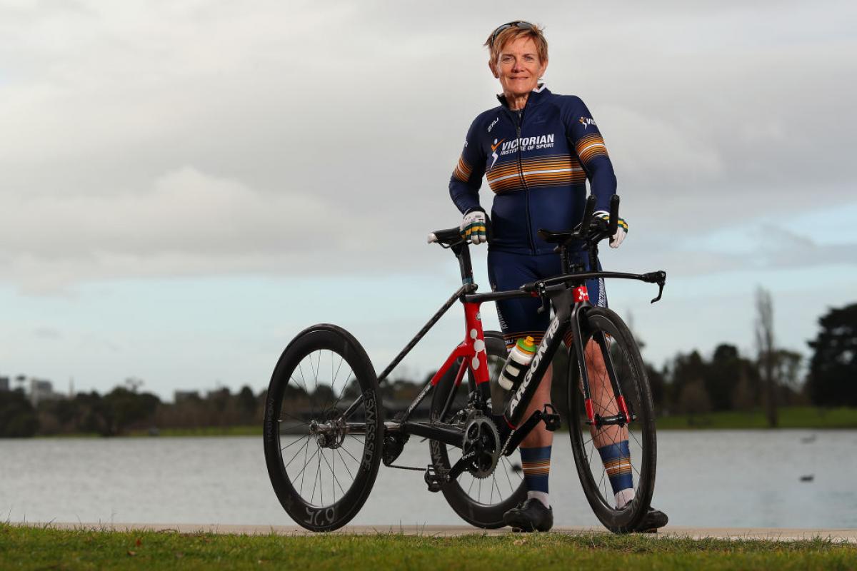 Woman poses next to her tricycle