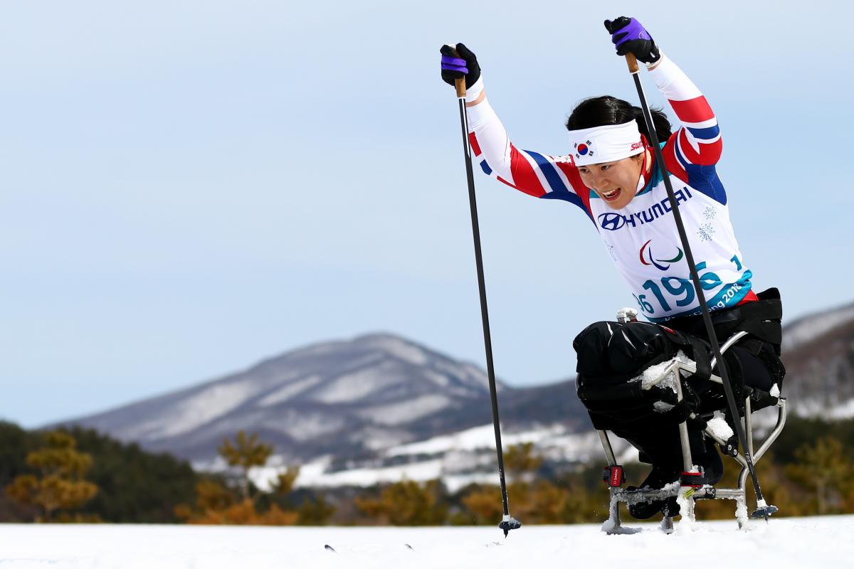 A female sit-skier in a Para cross-country competition