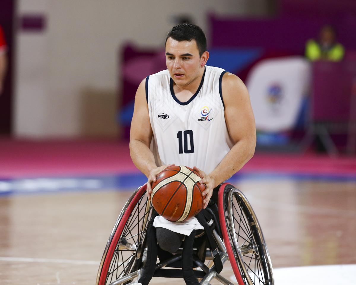 Colombian wheelchair basketball player Jose Leep focused with the ball in his hands